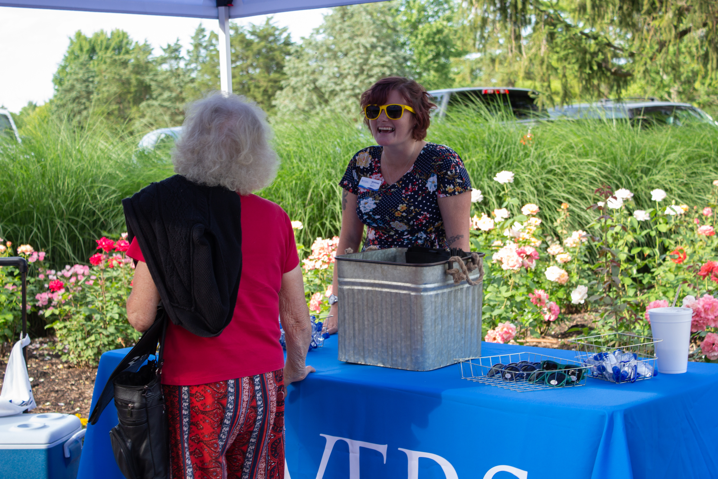 3Rivers team member greets an attendee at a community event