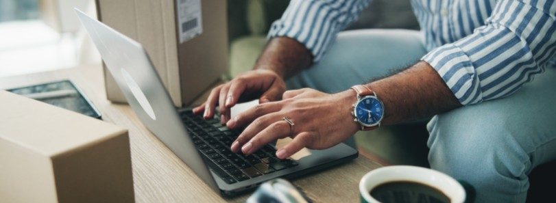 A man typing on a laptop