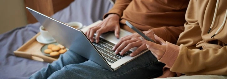 A couple looking something up on their laptop