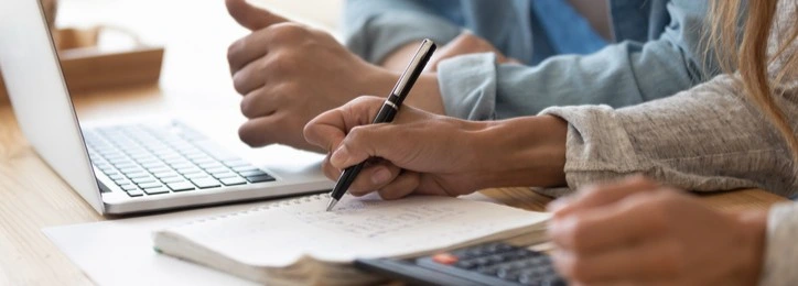 A couple writing down their finances