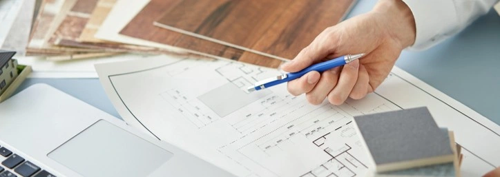 A person looking at blueprints