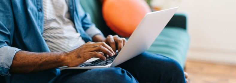 A man typing on a laptop