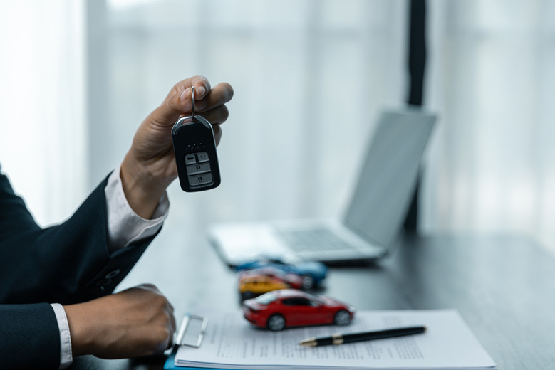 A dealer holding car keys
