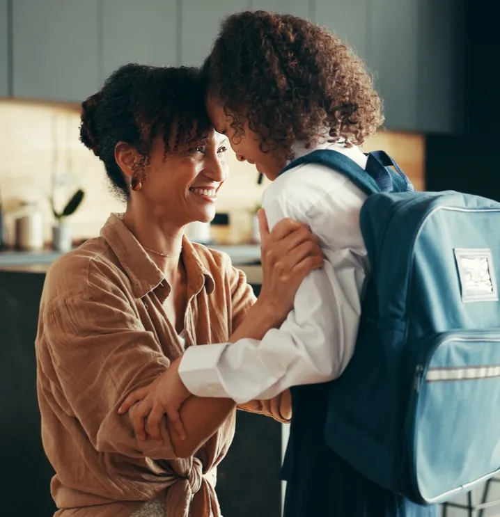 A mom sending her daughter to school