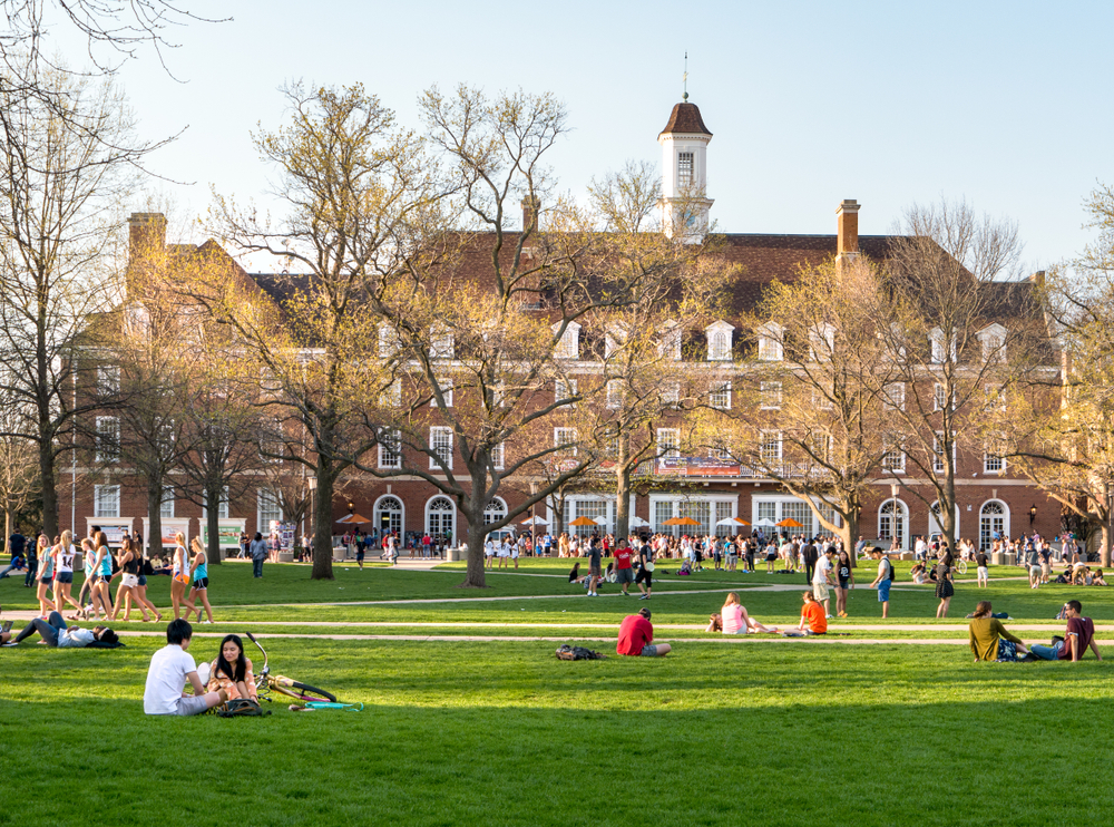 Students outside on the lawn of a college campus.