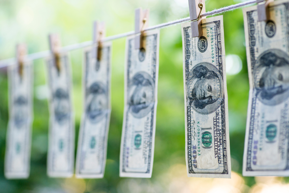 Hundred dollar bills hanging on clothesline