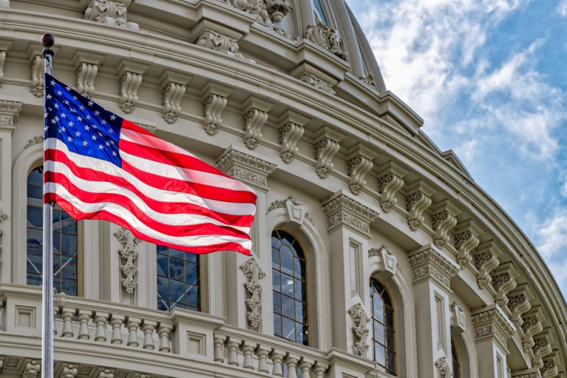 An American Flag waving in front of the Capitol Building.