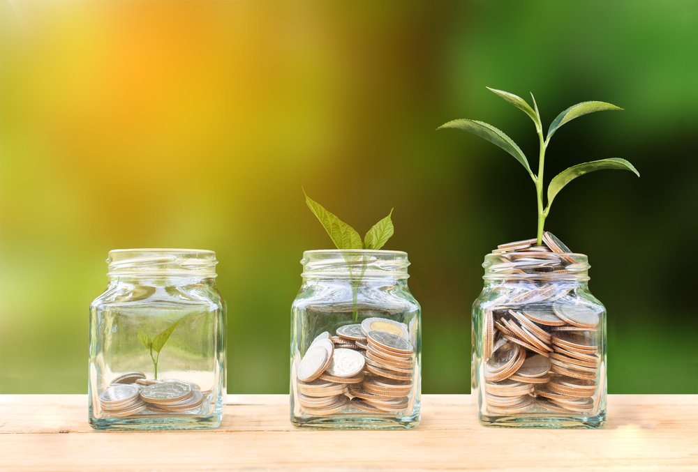 Three jars filled with coins.