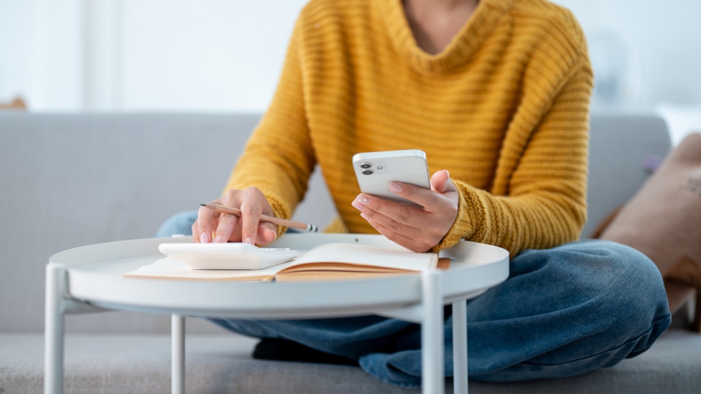 Woman on phone with calculator