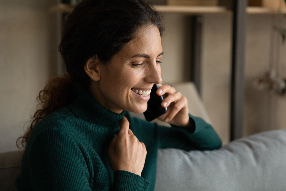 Woman smiling and talking on mobile phone